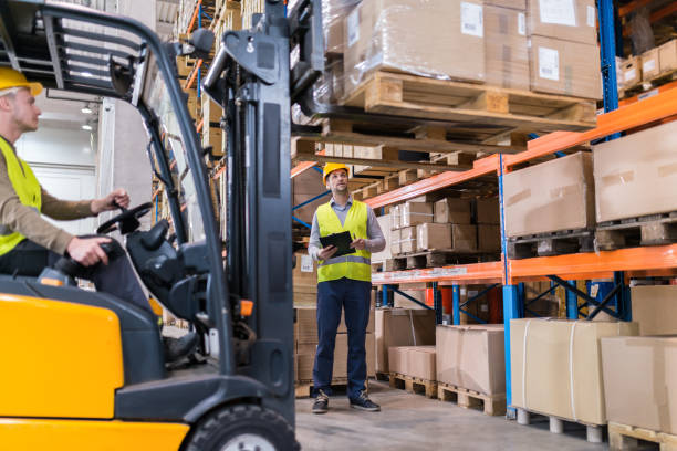 Forklift lifting load in a warehouse